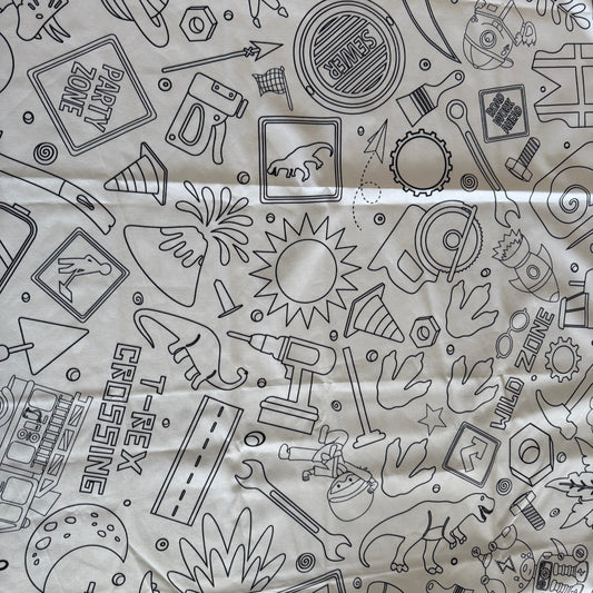 White fabric tablecloth with black line art designs of various boy objects and text.
