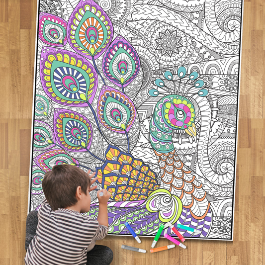 little boy coloring a large peacock coloring poster on a wood floor with markers