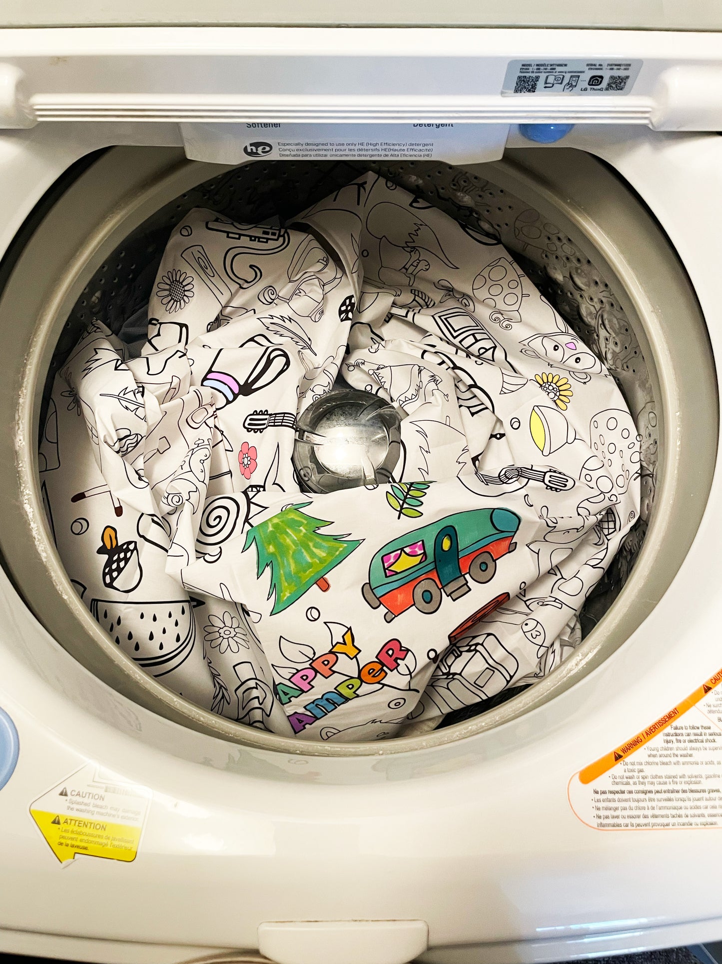 Children's coloring book with drawings inside a washing machine
