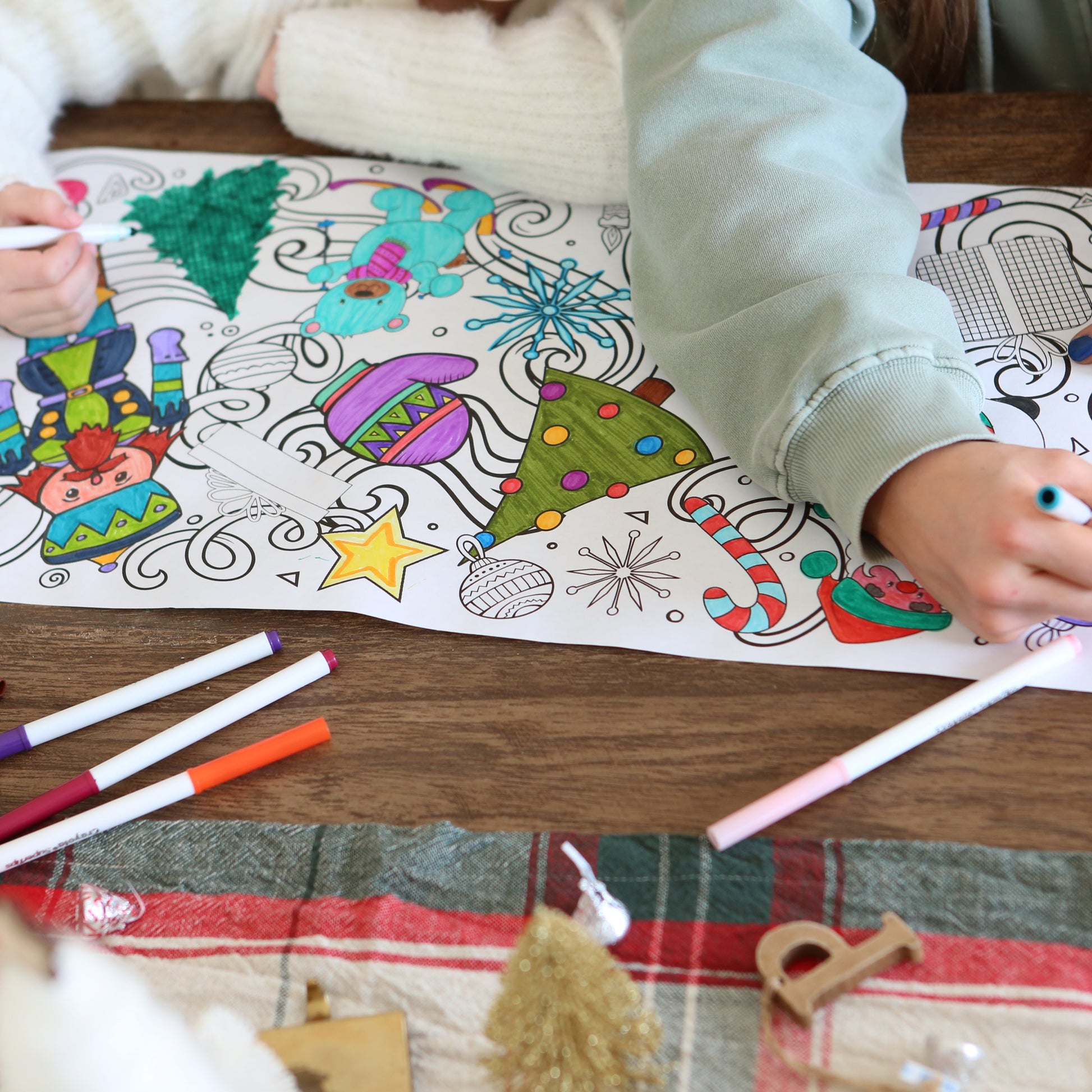 long coloring page with Christmas graphics on it being colored. 
