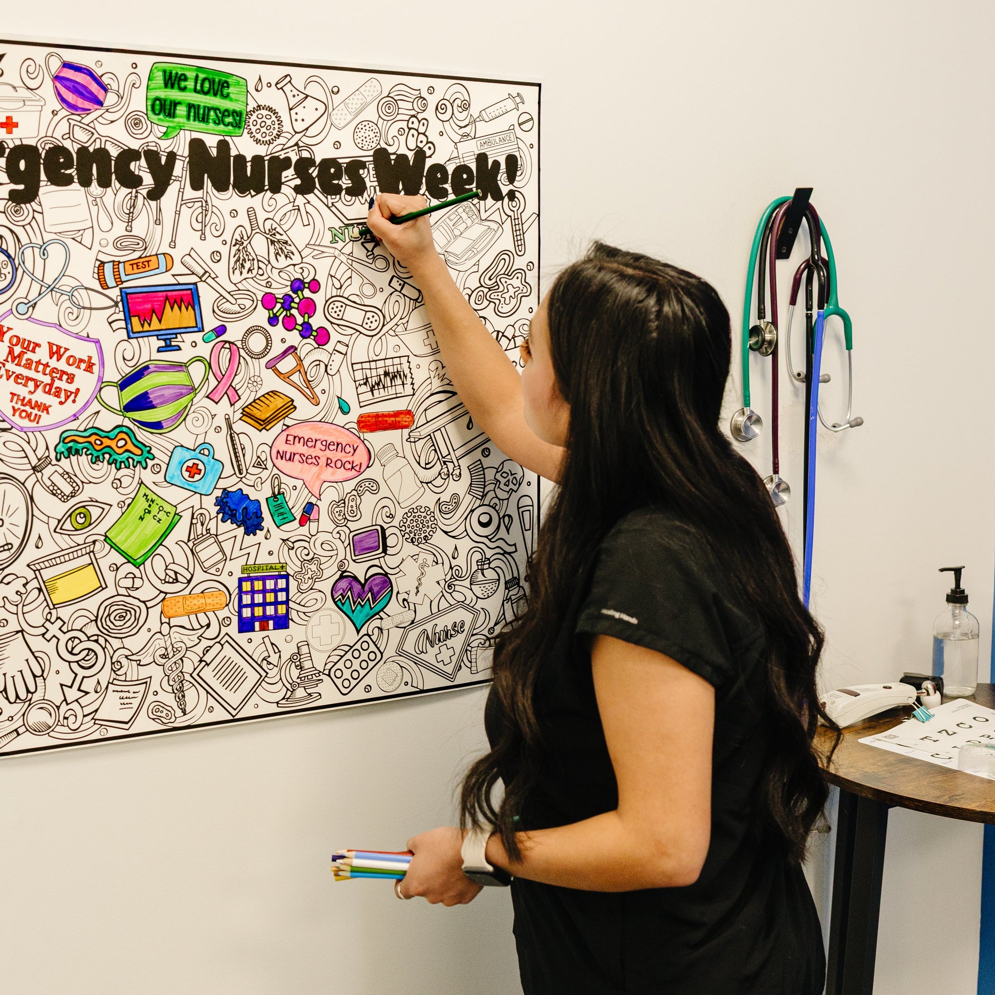 Nurse coloring on a personalized nurses week poster.  A bulletin board with 'Nurses Week' decorations in a medical setting.