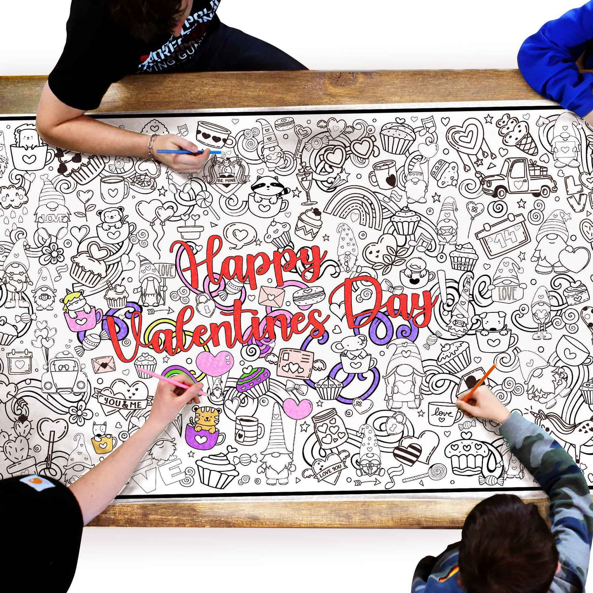 An image looking down on 4 people coloring a giant Happy Valentine's Day coloring poster.  The poster is packed with graphics of hearts and desserts and cute animals and gnomes. 
