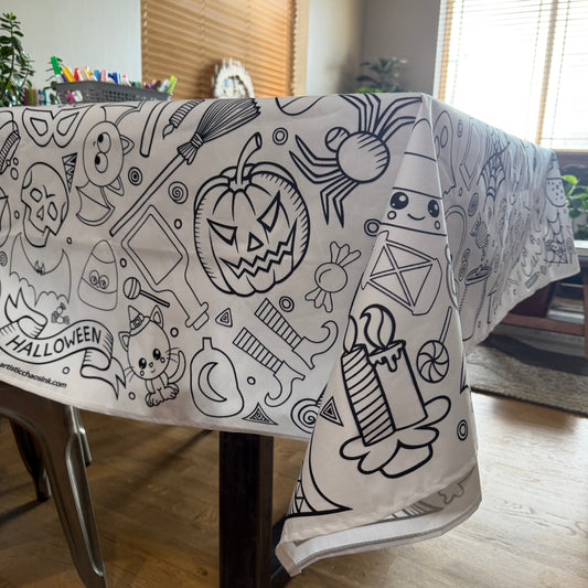 Table with Halloween-themed design coloring tablecloth on a wooden table