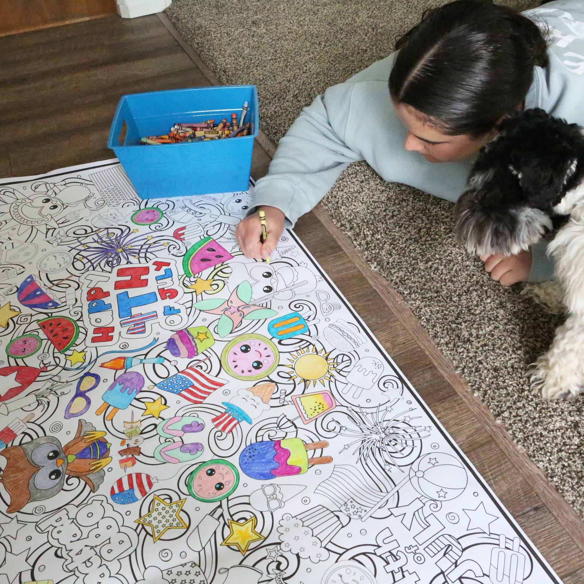 person laying on the floor coloring a 4th of july coloring banner by Artistic Chaos Ink. Banner has all kinds of summer graphics