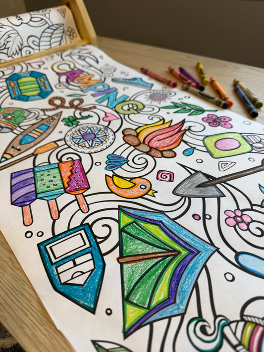Coloring roll paper with tent, popcicles, camp fire, raft, canoe, shovel, rope and more. Crayons are sitting to the side.  