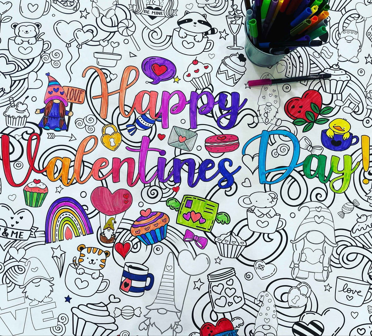 a close-up image of a partially-colored coloring poster with a Valentine's Day theme.  It shows the words Happy Valentines Day. The poster is covered with cute graphics of hearts, and animals, desserts, gnomes, and shapes.  There is a cup with markers standing on the poster 