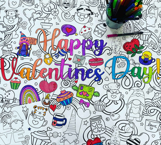 a close-up image of a partially-colored coloring poster with a Valentine's Day theme.  It shows the words Happy Valentines Day. The poster is covered with cute graphics of hearts, and animals, desserts, gnomes, and shapes.  There is a cup with markers standing on the poster 