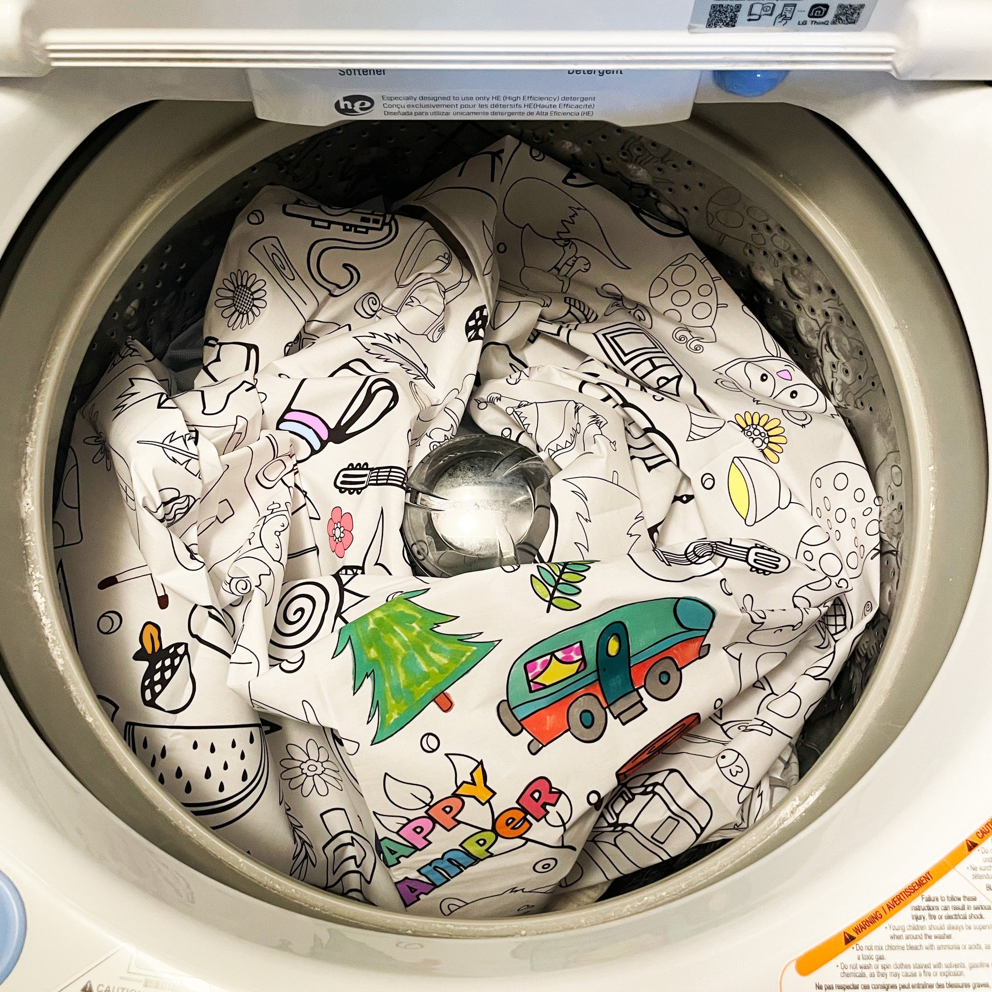 Children's coloring fabric coloring tablecloth with colored drawings inside a washing machine