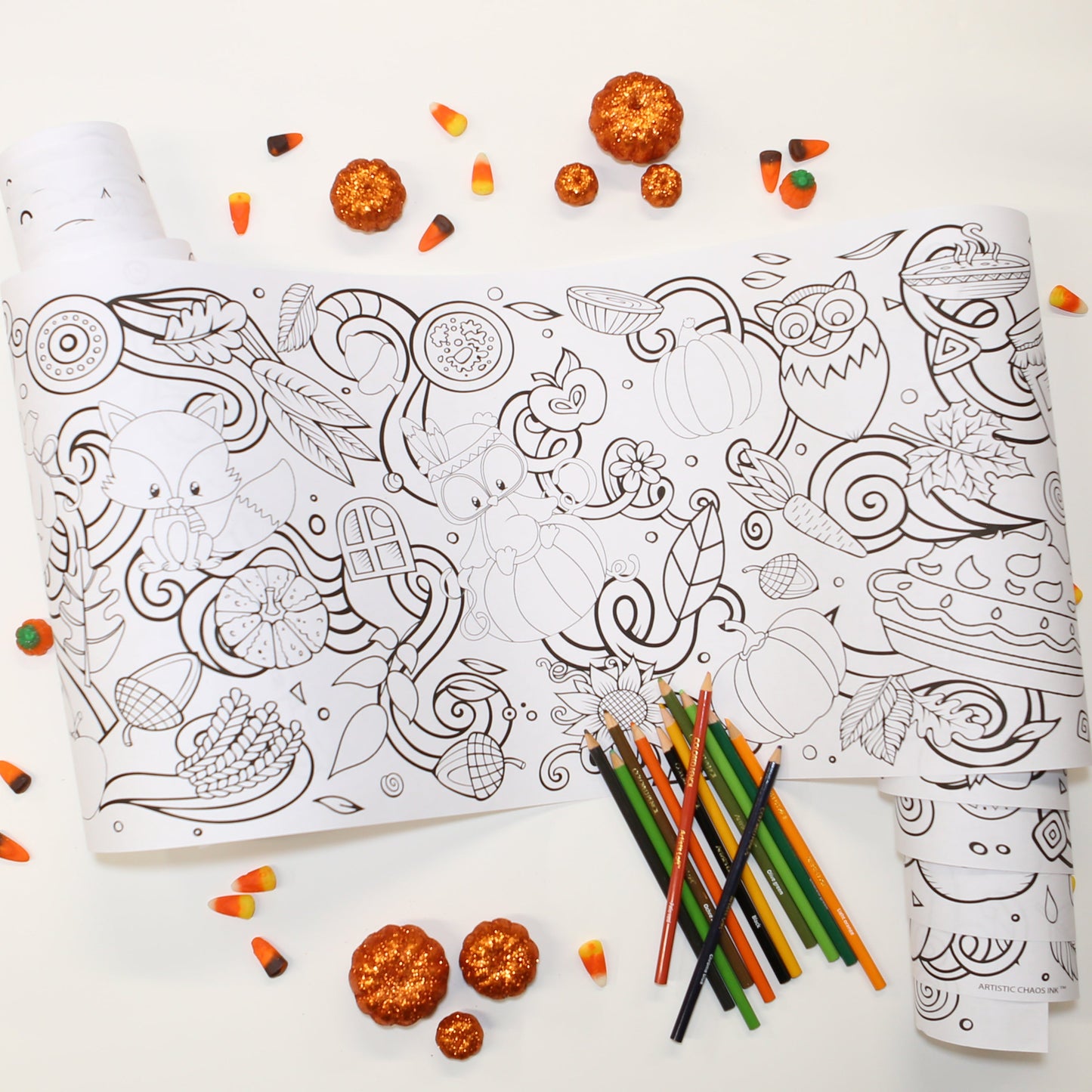 Fall Coloring Roll with sparkly pumpkins and candy corn and a pile of colored pencils.