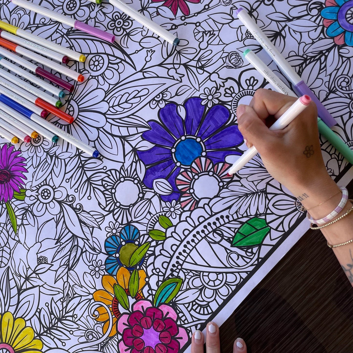 Floral Coloring banner by artistic chaos ink  with a womans hand coloring it.