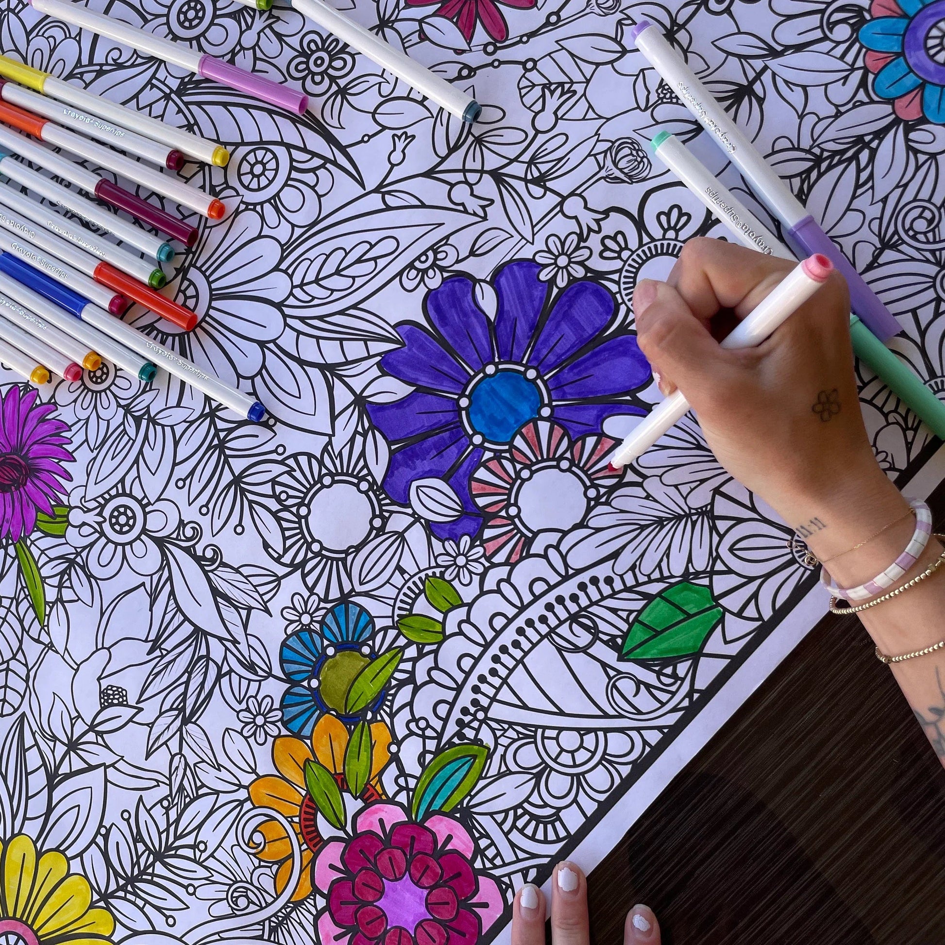 Floral Coloring banner by artistic chaos ink  with a womans hand coloring it.