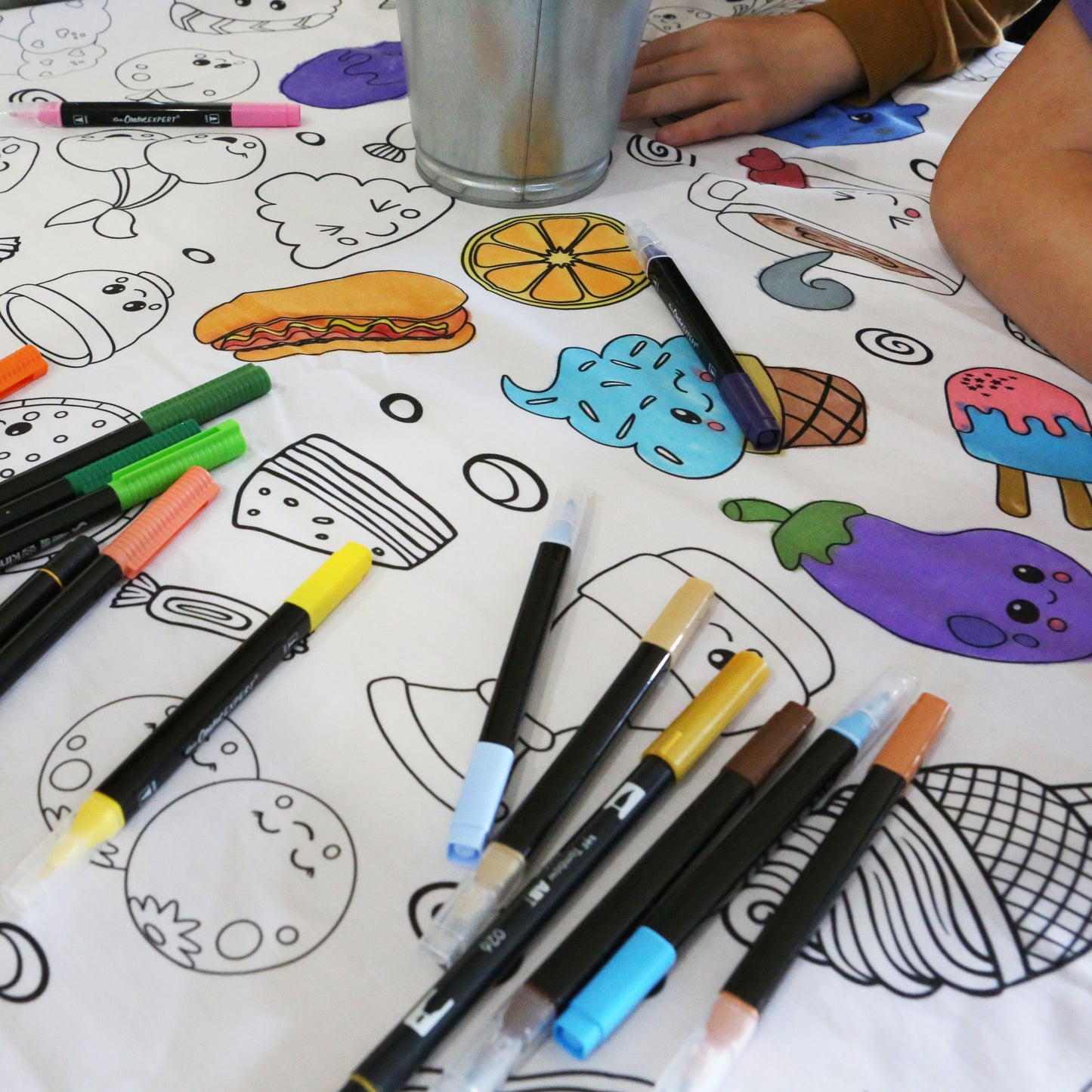 Coloring fabric tablecloth made by Artistic Chaos Ink an activity with markers and a 2 kids sitting at a table. 