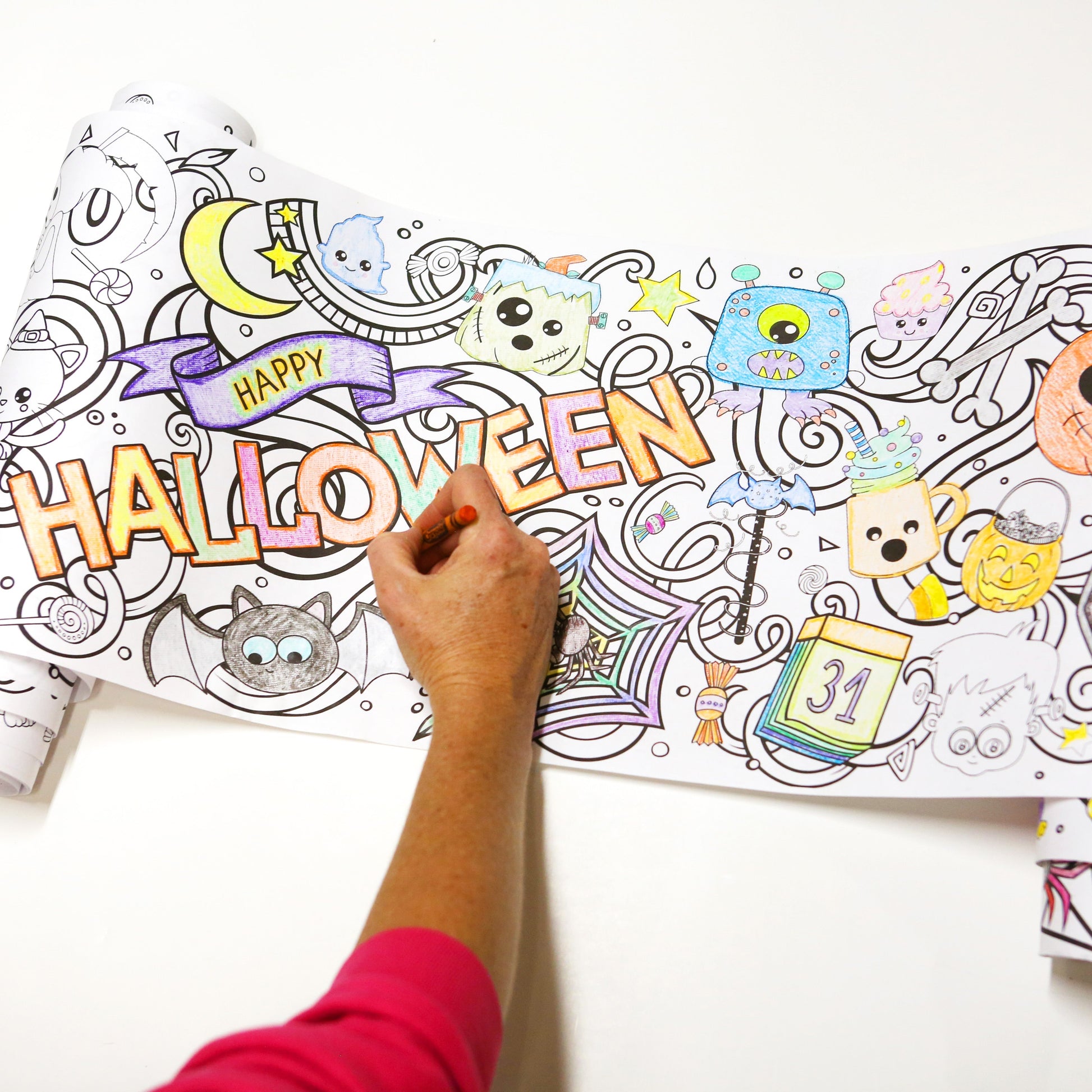 Halloween Coloring Roll being colored on white background